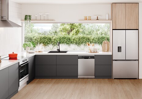 Modern kitchen with Westinghouse stainless steel appliances, including built-in oven, dishwasher, and French door fridge, featuring dark grey cabinets, white countertops, and garden-facing windows.